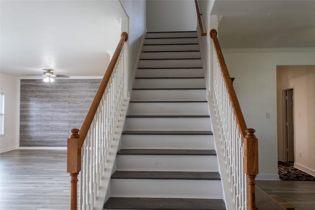 staircase featuring hardwood / wood-style floors and ornamental molding