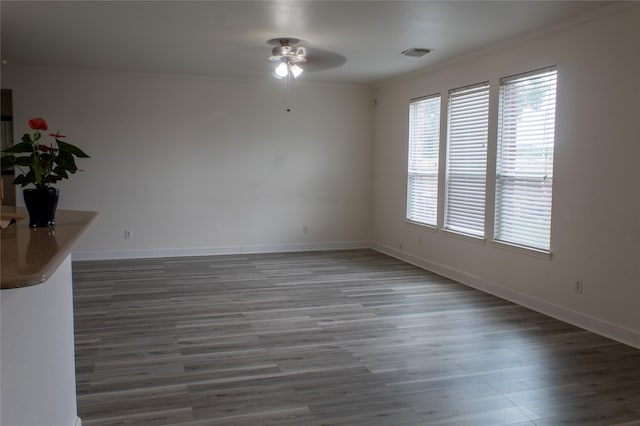 unfurnished room featuring hardwood / wood-style flooring, ceiling fan, and ornamental molding