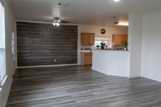 unfurnished living room with dark hardwood / wood-style flooring and ceiling fan