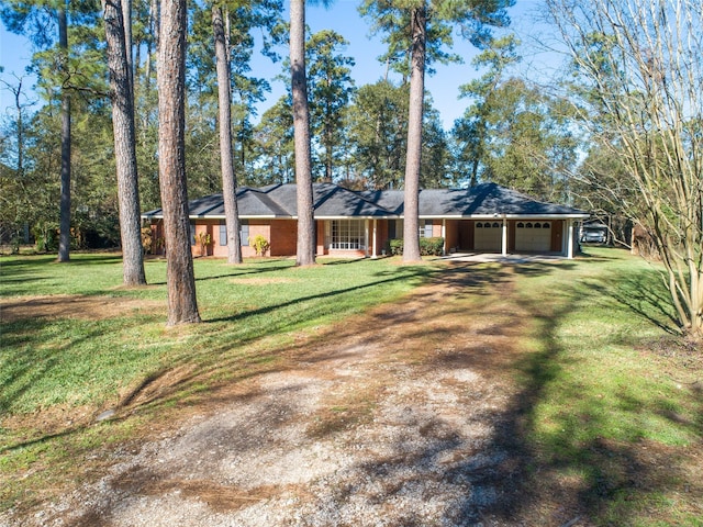 ranch-style home with a garage and a front lawn