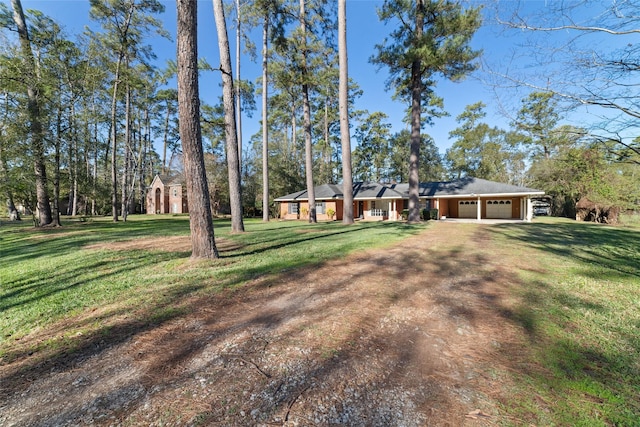 single story home featuring a front yard and a garage