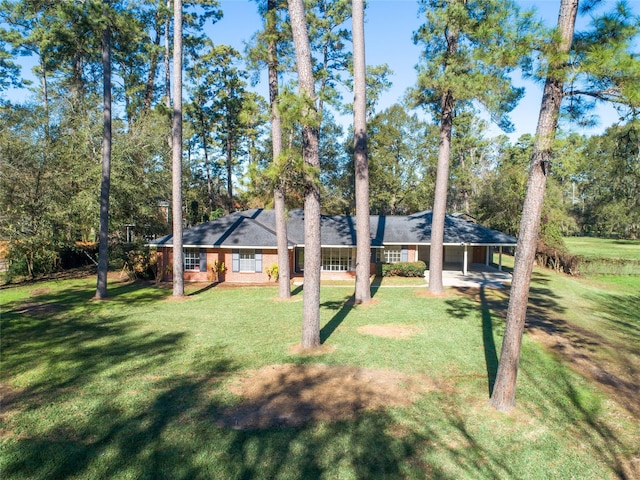 view of front of property with a carport and a front lawn