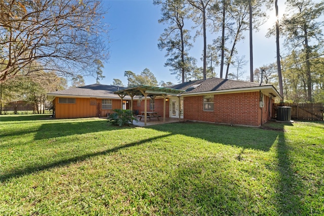 rear view of house featuring a yard, a patio, and central AC