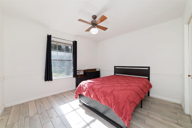 bedroom with light hardwood / wood-style floors and ceiling fan