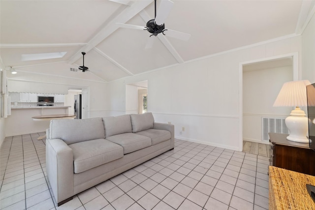 living room with light tile patterned floors, lofted ceiling with skylight, and ceiling fan