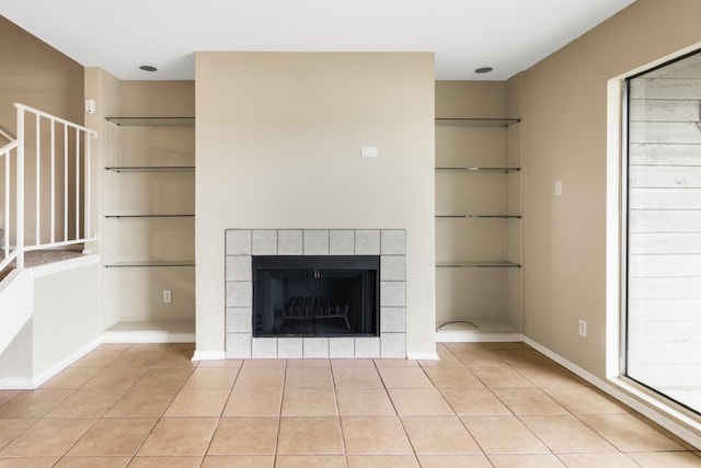 room details with built in shelves and a tiled fireplace