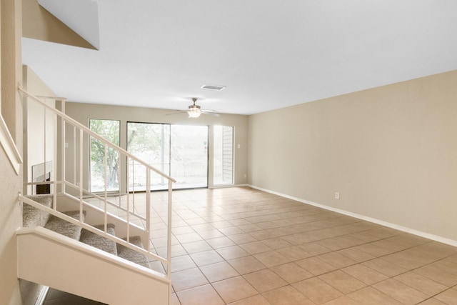 unfurnished living room with light tile patterned floors and ceiling fan