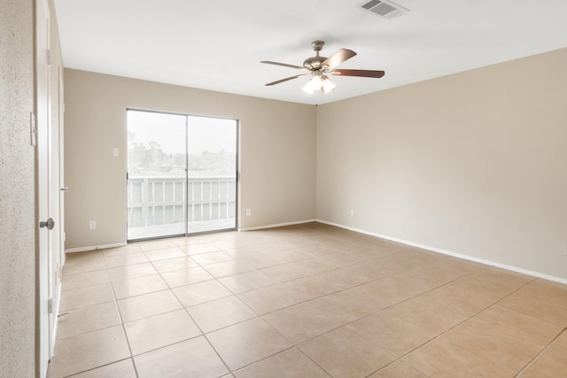 spare room featuring ceiling fan and light tile patterned floors