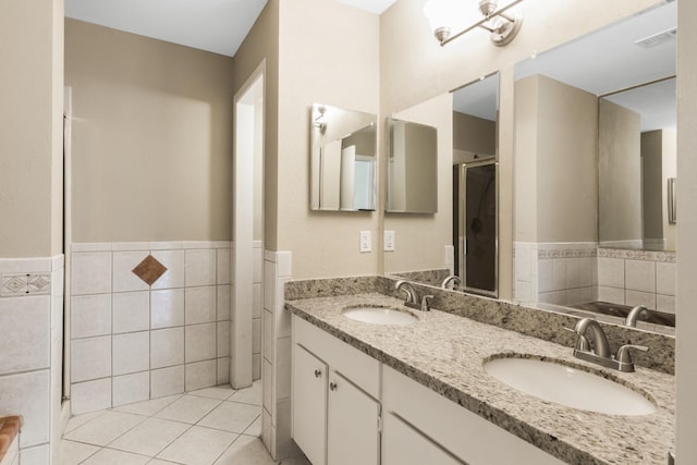 bathroom featuring tile patterned floors, vanity, and tile walls