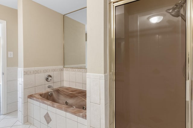 bathroom featuring plus walk in shower and tile patterned floors