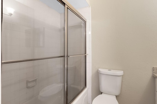 full bathroom with vanity, toilet, and enclosed tub / shower combo