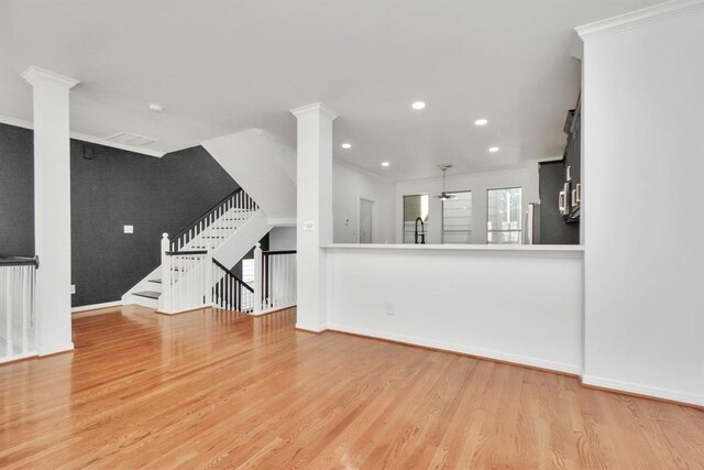 unfurnished living room featuring light hardwood / wood-style flooring and ornamental molding