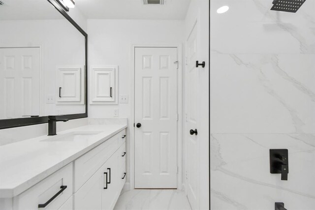 bathroom with vanity and walk in shower