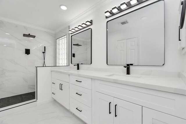 bathroom featuring vanity, a tile shower, and crown molding