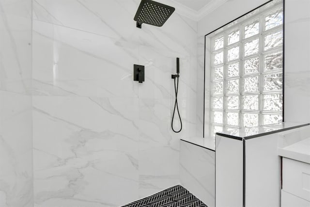 bathroom featuring tiled shower and ornamental molding