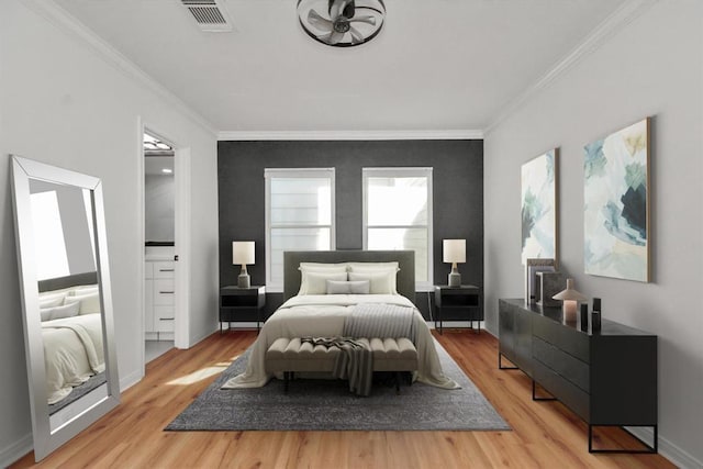 bedroom with crown molding and light hardwood / wood-style flooring