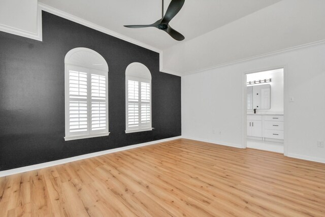 unfurnished bedroom with crown molding, ceiling fan, ensuite bathroom, and light hardwood / wood-style floors