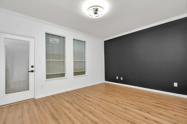 empty room featuring light hardwood / wood-style flooring and ornamental molding