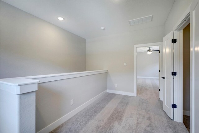 corridor with light colored carpet