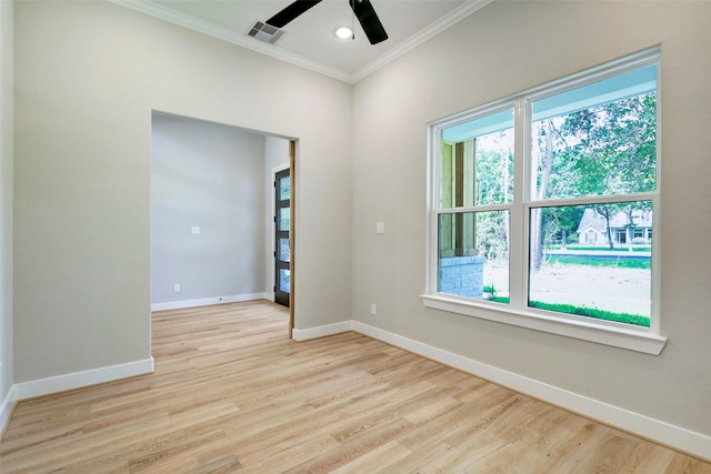 empty room featuring ceiling fan, crown molding, and light hardwood / wood-style flooring