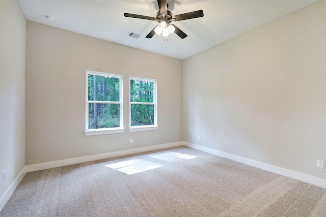 empty room featuring ceiling fan and carpet