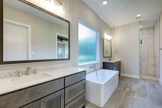 bathroom featuring vanity, ceiling fan, and plus walk in shower