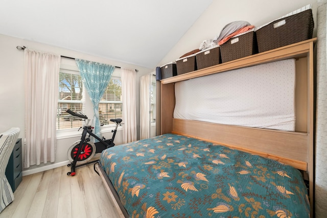 bedroom with wood-type flooring and lofted ceiling