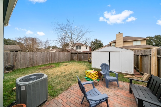 view of patio with central AC unit and a shed