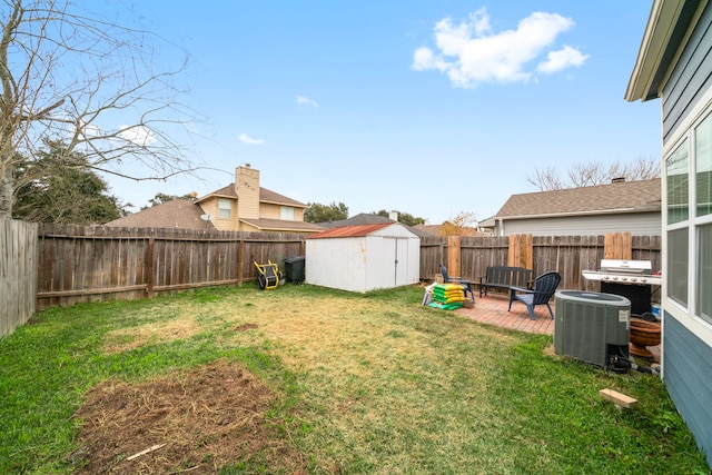 view of yard with a shed, a patio, and central air condition unit