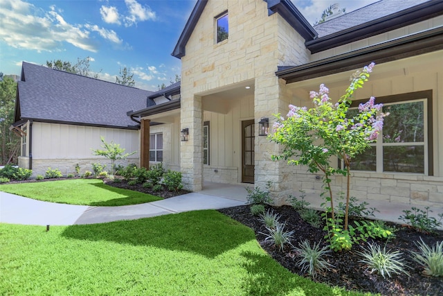 entrance to property featuring a lawn