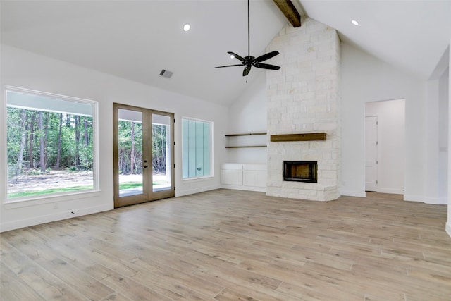 unfurnished living room featuring french doors, light wood-type flooring, ceiling fan, high vaulted ceiling, and beamed ceiling