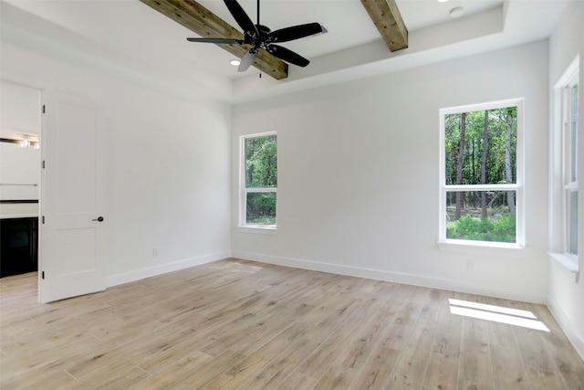 empty room featuring ceiling fan, light hardwood / wood-style floors, and a wealth of natural light