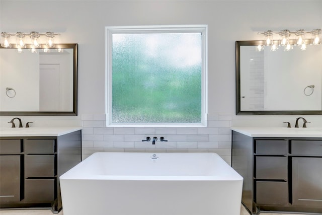 bathroom with a bath and vanity