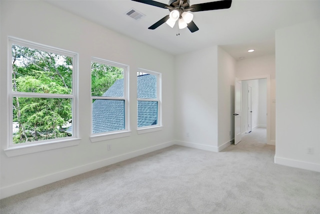 carpeted spare room featuring ceiling fan