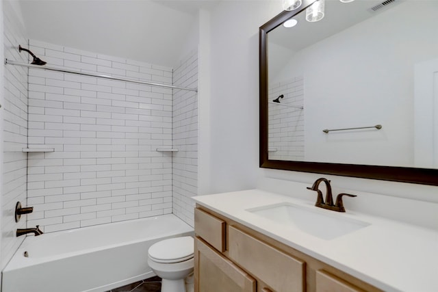 full bathroom with tile patterned flooring, vanity, toilet, and tiled shower / bath