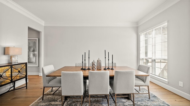 dining area with wood-type flooring and ornamental molding