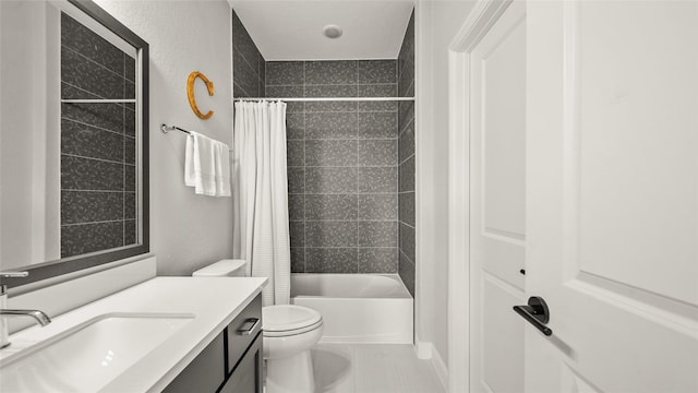 full bathroom with tile patterned floors, shower / bath combo, toilet, and vanity