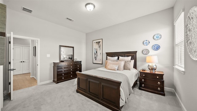 bedroom featuring light carpet