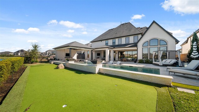 back of property featuring ceiling fan and a patio area