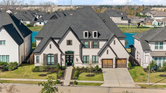 view of front of house with a front yard and a garage