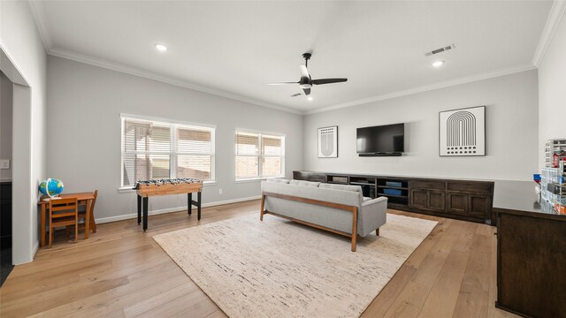 living room featuring light hardwood / wood-style flooring and ornamental molding