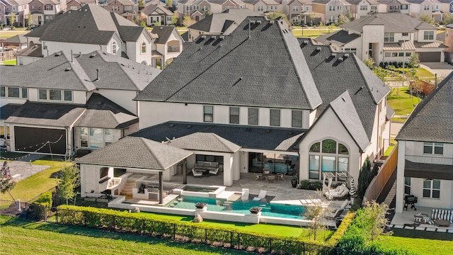 rear view of property with an outdoor living space and a patio