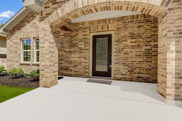 entrance to property with brick siding