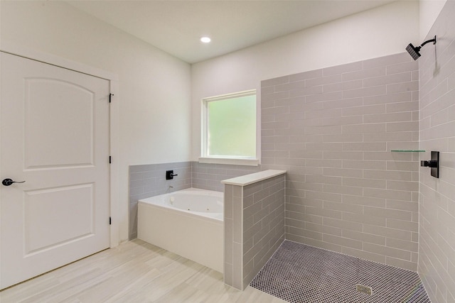 full bathroom with a garden tub, wood finished floors, a shower stall, and recessed lighting