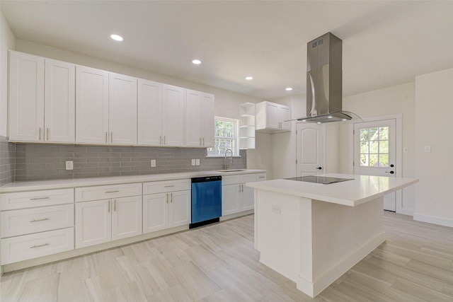 kitchen featuring light countertops, white cabinets, a kitchen island, island range hood, and dishwasher