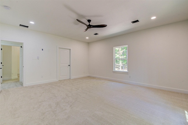 unfurnished room with a ceiling fan, light colored carpet, visible vents, and recessed lighting