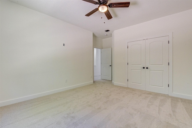 unfurnished bedroom with light carpet, visible vents, baseboards, ceiling fan, and a closet