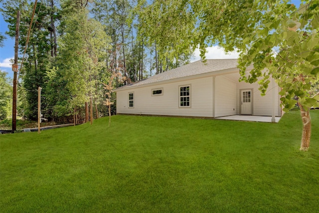 back of property with a patio and a lawn