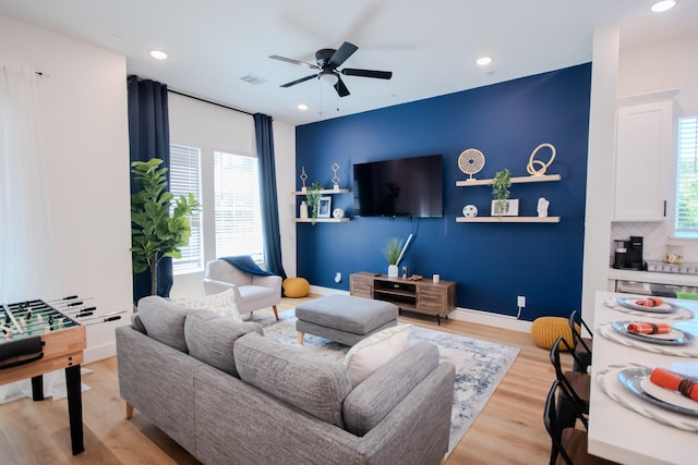 living room featuring ceiling fan and light wood-type flooring