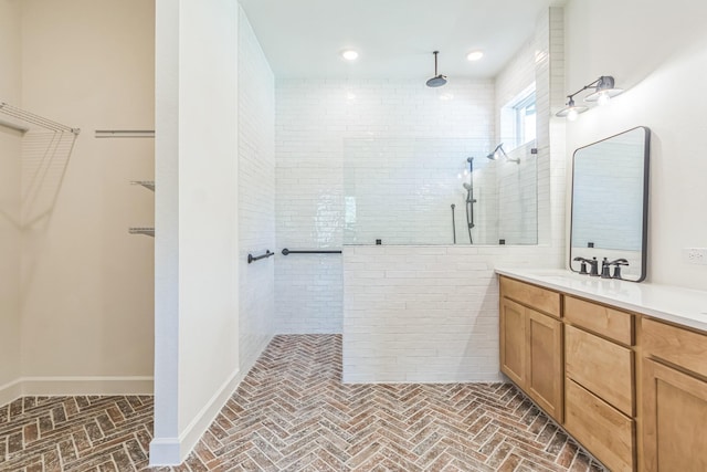 bathroom featuring vanity and a tile shower